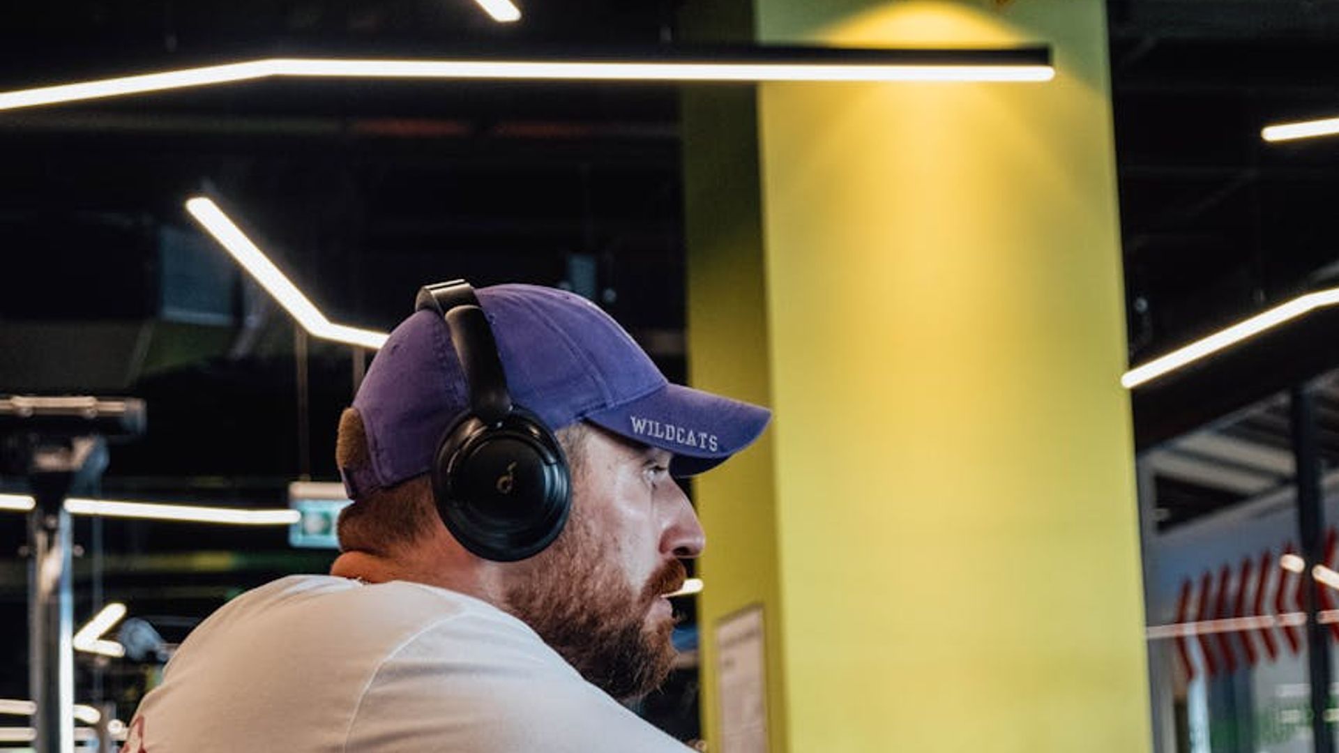 Athletic man performing strength exercises in a modern gym.