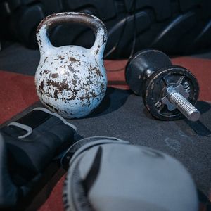 Selection of training weights and kettlebells on gym floor.